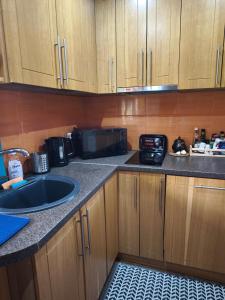 a kitchen with a sink and a microwave at Holiday house/Brīvdienu māja in Kegums in Ķegums