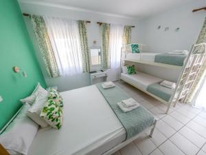 a small room with a bed and a bunk bed at Menta Studios in Skala Potamias