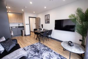 a living room with a couch and a table at Brand-New Borehamwood 1-Bed, 1-Bath Flat in Borehamwood