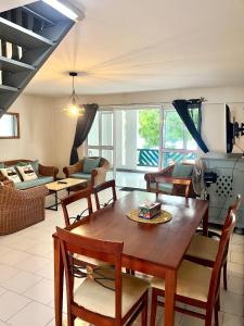 a living room with a wooden table and chairs at Nenuphar 3 Bedroom-Apartment in Flic-en-Flac