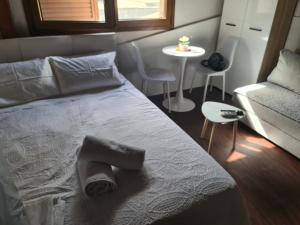 a bedroom with a bed and a chair and a table at Xristos Studio Psakoudia Halkidiki in Psakoudia