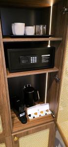 a cabinet with a microwave and a box in it at C a s a B e a s t in Split