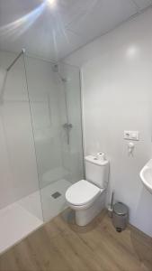 a bathroom with a shower and a toilet and a sink at Mirador al puente del río Genil in Puente-Genil