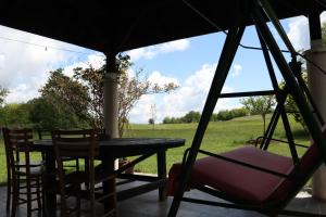 a patio with a table and two chairs and a table and a swing at EcoFit Povlen in Valjevo
