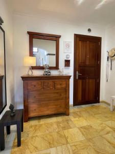 a room with a wooden dresser and a mirror at Villa Casa Karoline with a sunny terrace, heated pool, comfort and privacy in a quiet neighborhood in Playa Blanca +16 photos