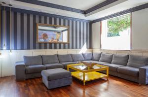 a living room with a couch and a coffee table at Olympia Consul del Mar in Valencia
