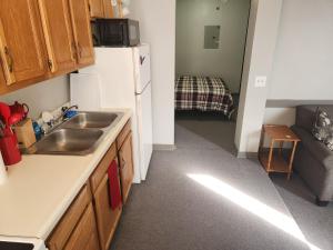 a small kitchen with a sink and a refrigerator at Goose's Hall  +3 photos