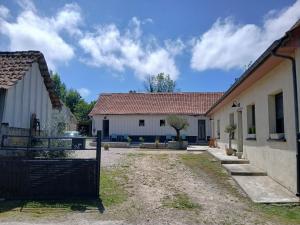 a house with a gate in front of a building at Les Oliviers in Chériennes +18 photos