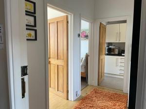 a hallway with a door leading to a kitchen at Me and You Sleeps 2 - Central Apartment in Berwick Northumberland in Berwick-Upon-Tweed