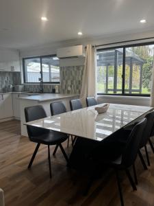 a kitchen and dining room with a table and chairs at Teresa Ct in Rye