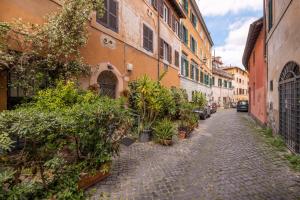 an alley with potted plants on the side of a building at Panieri Apt - Homkeey Apartments in Rome +6 photos
