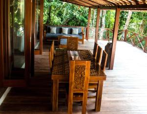 Un comedor con una mesa y sillas y un sofá. en Kaloi Villa, en Bedahulu