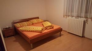 a bedroom with a bed with two pillows on it at Apartment Kati in Novigrad Istria
