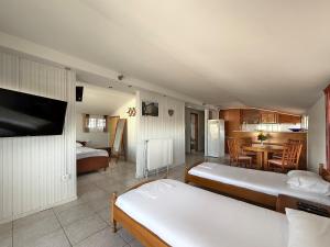 a living room with two beds and a dining room at Lucia Loft by SDR in Paralia Katerinis