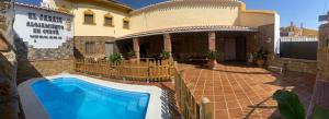 a house with a swimming pool in front of it at Cueva El Jaraiz in Guadix