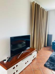 a living room with a large flat screen tv at Tamuda golf in Cabo Negro