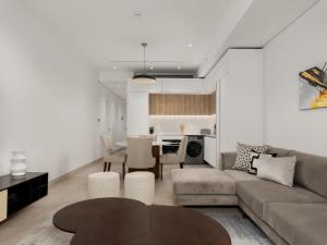 a living room with a couch and a table at The Rubik: Luxury secure apartment in Cape Town in Cape Town