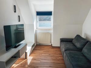 a living room with a couch and a television at Your Home Base - Vacation & Work close to Munich in Dachau
