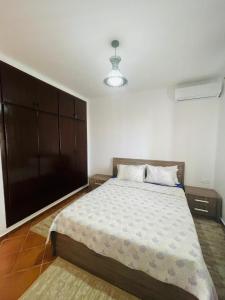 a bedroom with a large bed and a brown cabinet at Tamuda golf in Cabo Negro +19 photos