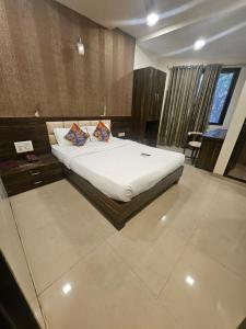 a bedroom with a bed with two pillows on it at Prime Hotel Addore Palácée - Near Mumbai Airport , Visa Consultant , Jio World Convention Centre BKC in Mumbai