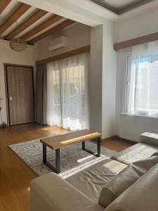 a living room with a couch and a coffee table at The Ancient Theatron Luxury suites in Larisa