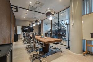 a conference room with a long table and chairs at Unity Helsinki - A Studio Hotel in Helsinki
