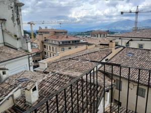 a view of roofs of buildings with a crane at Ninfea Residenza Storica in Spoleto