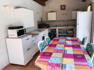 a kitchen with a table with a colorful quilt on it at la Farigoulette in Lorgues