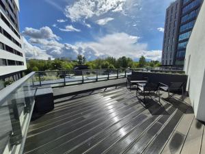 a balcony with two chairs and a table on a building at Aura Towers in Bydgoszcz