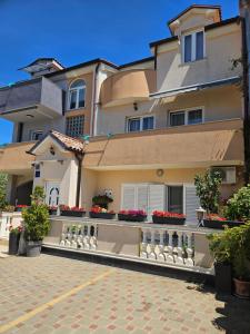 a large house with flowers on a brick driveway at Apartmani M&L in Medulin