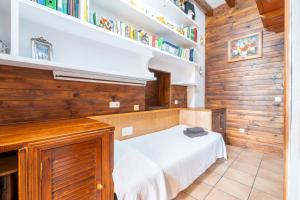 a bedroom with a bed in a room with bookshelves at Los Abilios in Palma de Mallorca +26 photos