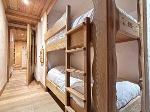 two bunk beds in a room with wooden floors at Appartement 3 pièces jusqu'à 6 pers, Méribel centre, proche pistes et commerces - FR-1-411-68 in Les Allues