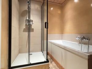 a glass shower in a bathroom with a tub at Appartement 3 pièces jusqu'à 6 pers, Méribel centre, proche pistes et commerces - FR-1-411-68 in Les Allues +9 photos