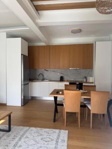 a kitchen with a table and chairs in a room at The Ancient Theatron Luxury suites in Larisa