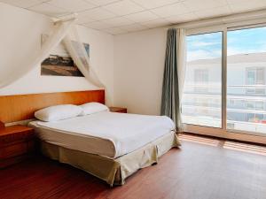 a bedroom with a bed and a large window at Vela Garden Resort in Alaçatı +92 photos