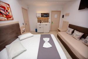 a small living room with a couch and a table at Amalia Mare in Nea Vrasna