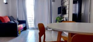a living room with a table and a couch at Elsueño in San Nicolás de los Arroyos