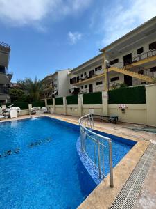 a swimming pool in front of a building at Metropolitan apart in Marmaris