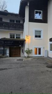 a large white house with a driveway and a building at Ferienwohnung Klein in Schönau am Königssee