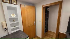 a room with a wooden door and a hallway at Ferienwohnung Klein in Schönau am Königssee