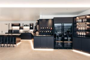 a bar in a room with a lot of wine bottles at Villa Weingarten in Caldaro