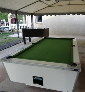 a pool table sitting under a pavilion with a pool table at Camping L'Evasion in Fontès