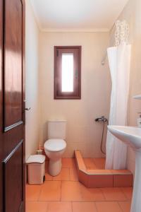 a bathroom with a toilet and a sink at F & B Collection - Loutra in Agia Paraskevi +31 photos