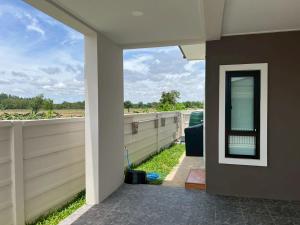 a view from the outside of a house with a patio at เคียงนา เฮ้าส์ นครพนม - KiangNa House Nakhon Phanom in Ban Noi Pho Kham