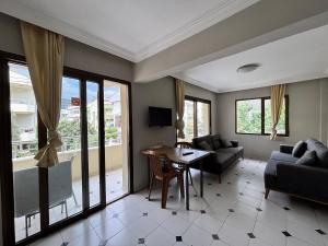 a living room with a table and a couch at Metropolitan apart in Marmaris