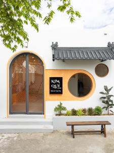 a building with a bench in front of it at Kim Quý Home in Phu Quoc