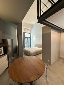 a room with a wooden table and a bed at Effealatapartments - EdenLoft in Senigallia