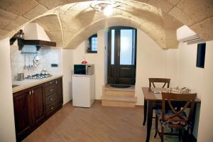 a kitchen with a table and a dining room at L'Angolo del Salento in Oria