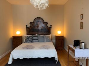a bedroom with a large bed with two night stands at Casa Agostini Bed and Breakfast in Farra di Soligo