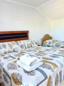 a bed with two towels on top of it at Hostal Mi Casa in Canela Baja